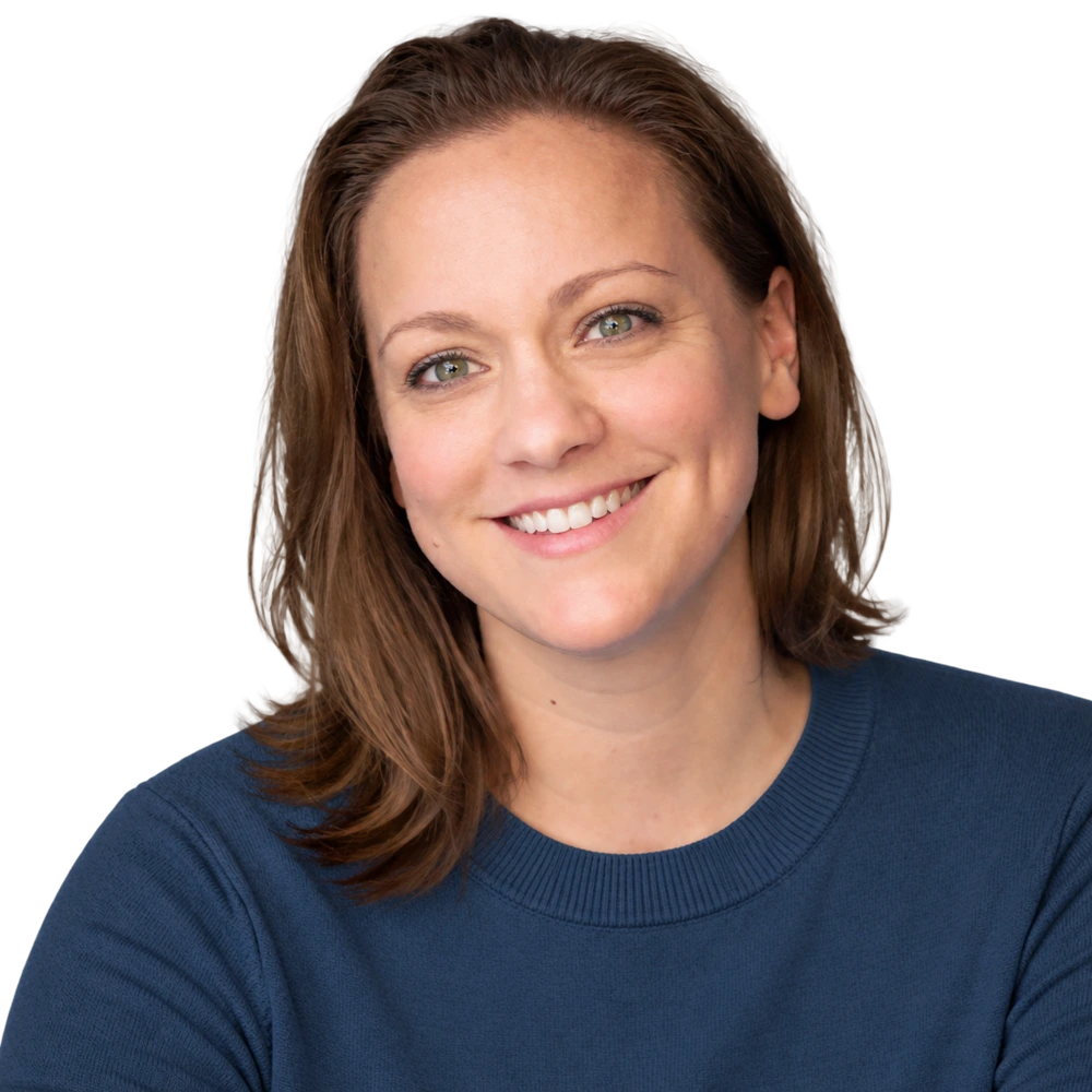 Brittany smiling in a dark blue sweater